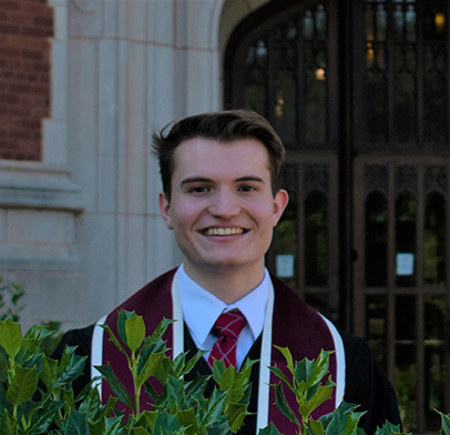 A picture of a young man with dark brown hair smiling